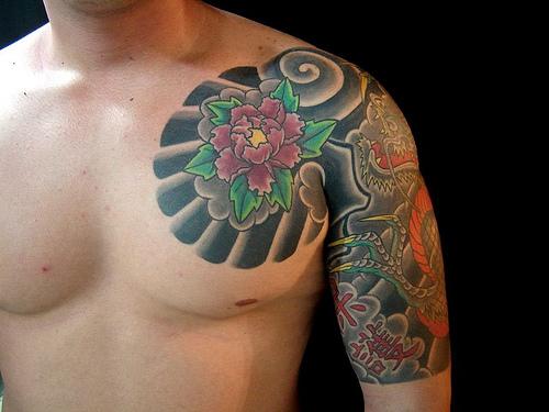 bee tattoo. daffodil. flower tattoo. Violet rose tattoo on the chest and red 