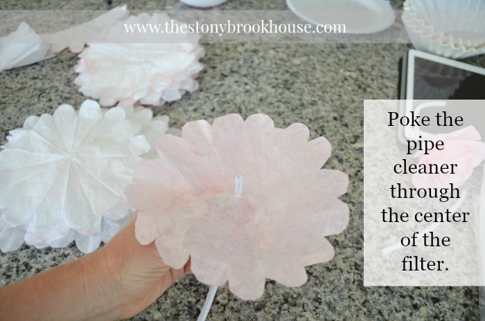 Poke the pipe cleaner through the coffee filter