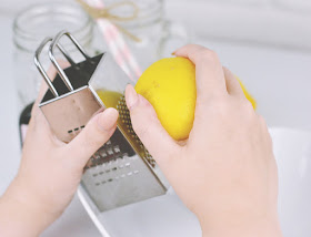 Removing zest from lemon using cheese grater