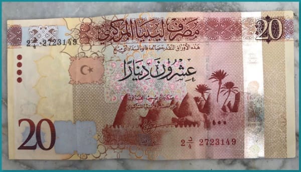 تخفيض قيمة الدينار الليبي بعد فرض ضريبة مشتريات الدولار
