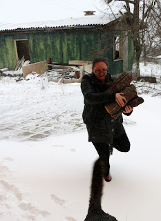 A collecting wood as the snow falls