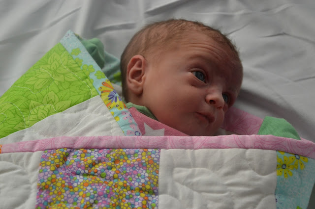 Baby wrapped up in the Girls Quilt