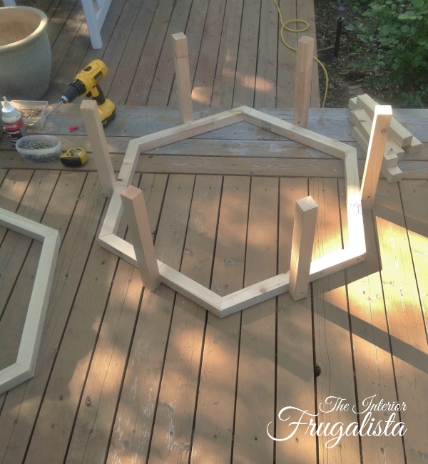 A budget-friendly DIY Adirondack Fire Bowl Coffee Table for a patio or deck with a unique hexagon pallet style for those cool summer evenings outdoors.