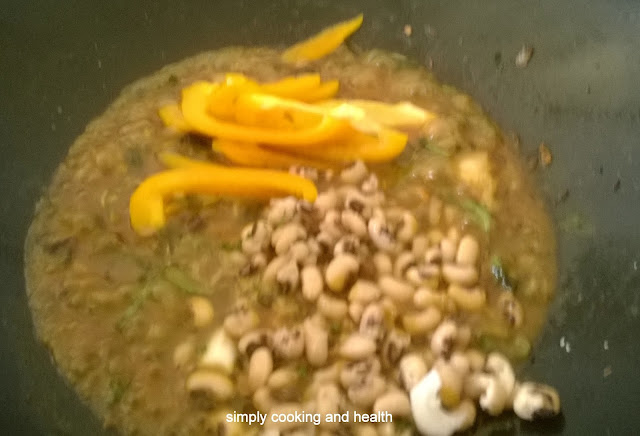 Adding the boiled black eye beans and bell pepper.