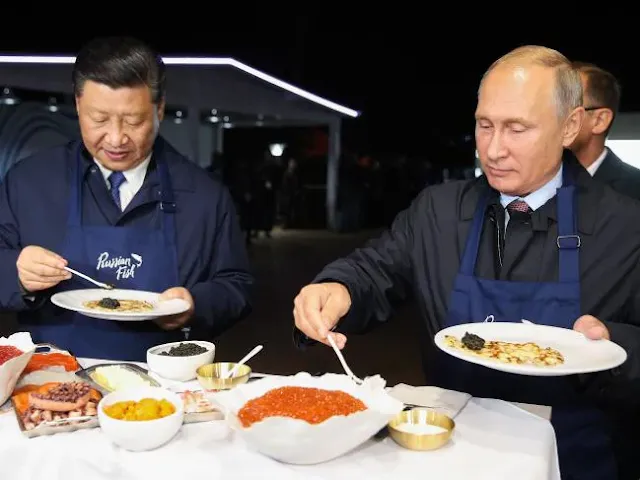 Russian President Vladimir Putin and his Chinese counterpart Xi Jinping cook pancakes during the Eastern Economic Forum in Vladivostok.