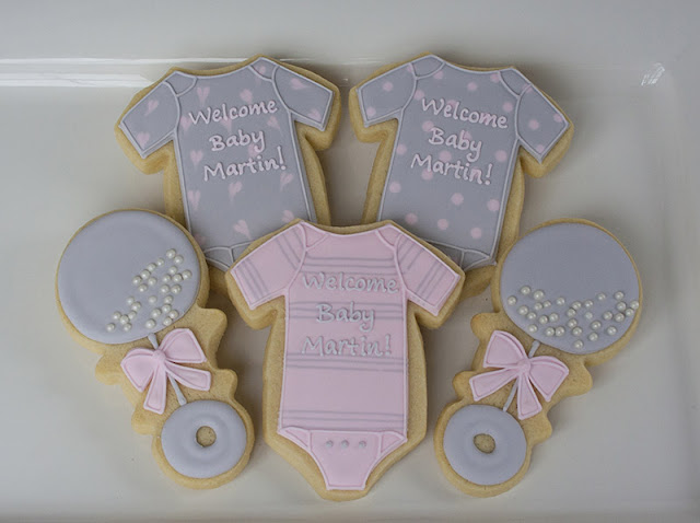 baby girl onesie and rattle cookies