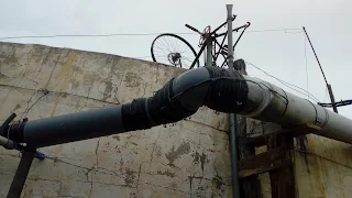 Wall of the water tank, before it a connection of the water pipes