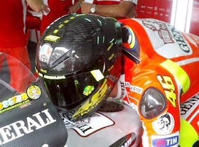 Valentino Rossi on MotoGP Ducati head resting on tank