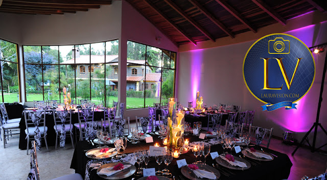 mesas decoradas con flores y velas con mantel oscuro, jardin al fondo de la hacienda Los Nogales