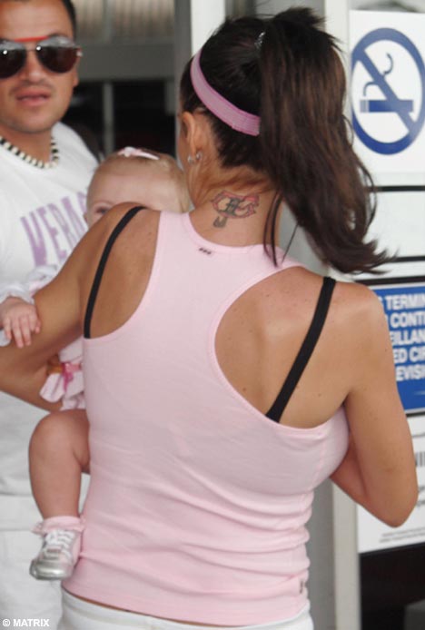 winged cross, back of neck. Christina Jordan flashes her new neck tattoo