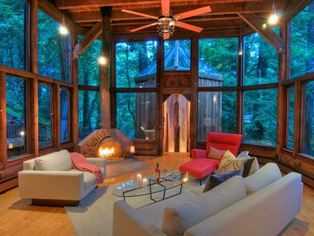 Photo of living room and the fireplace inside of tree house in the forest