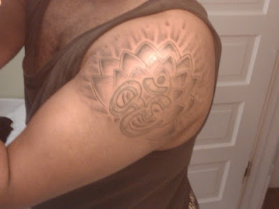  Studios I got my ohm tattoo enhanced with a lotus flower background.