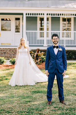 bride walking up behind groom for first look