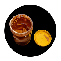 Image of a peanut butter container with some peanut butter left.