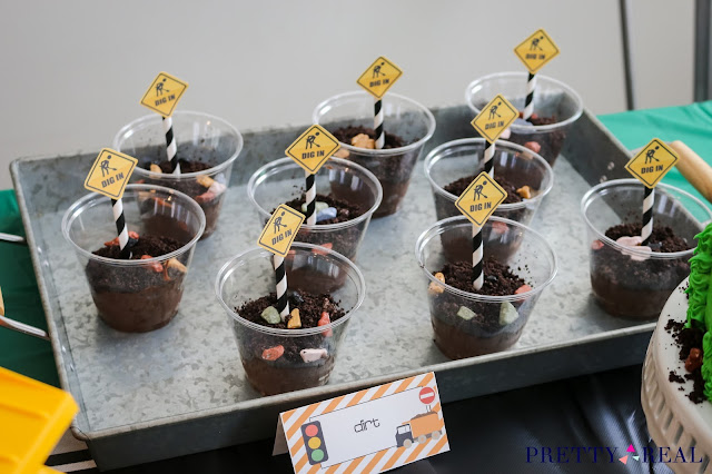 Pudding dirt cups on a galvanized tray at a construction themed birthday party