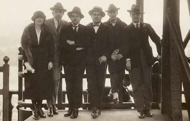 The five members of Les Six who collaborated on Les Mariés, with Jean Cocteau at the Eiffel Tower (1921): Germaine Tailleferre, Francis Poulenc, Arthur Honegger, Darius Milhaud, Jean Cocteau, Georges Auric (left to right)