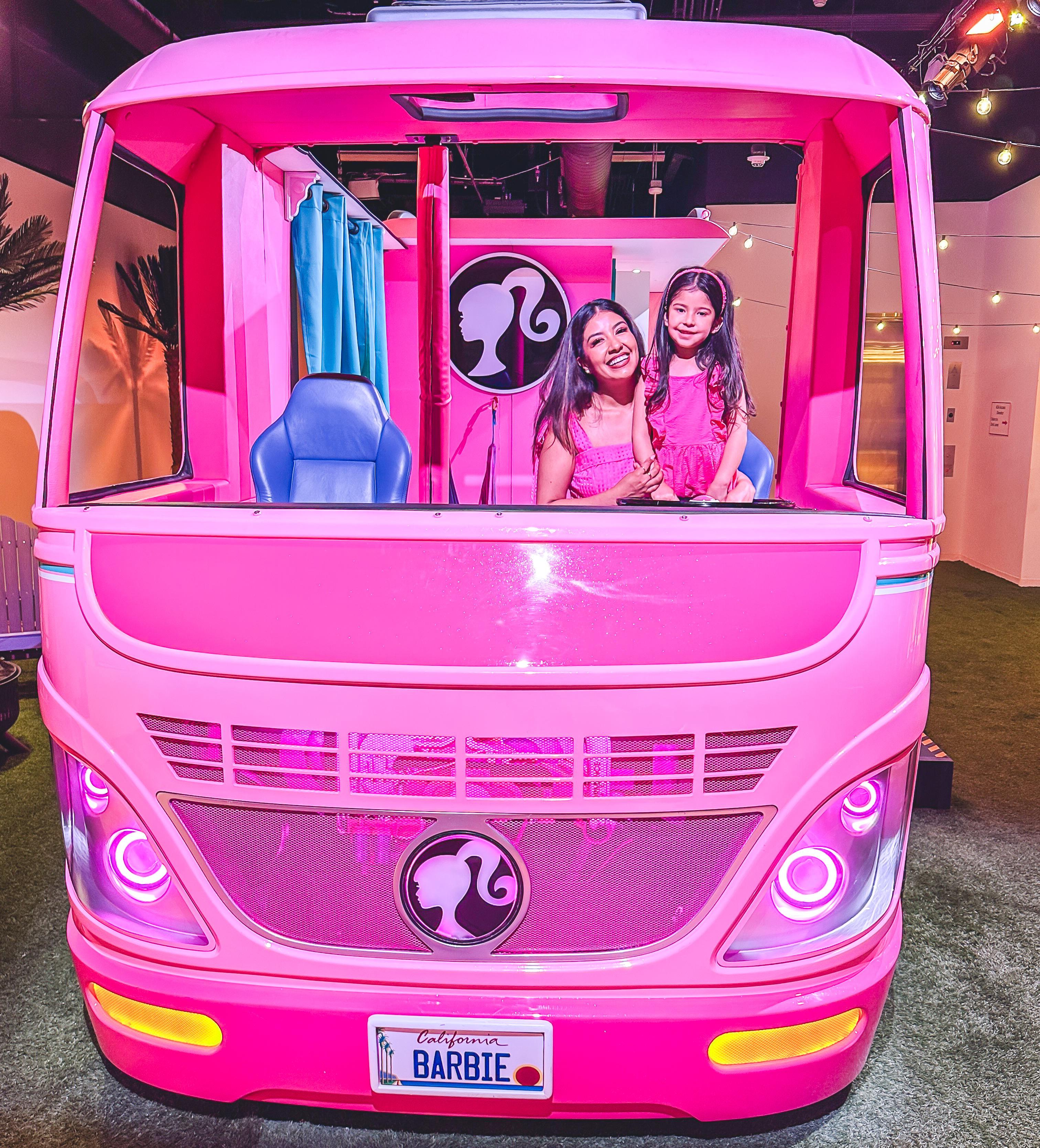 Mother and Daughter inside Barbie's life sized pink camper