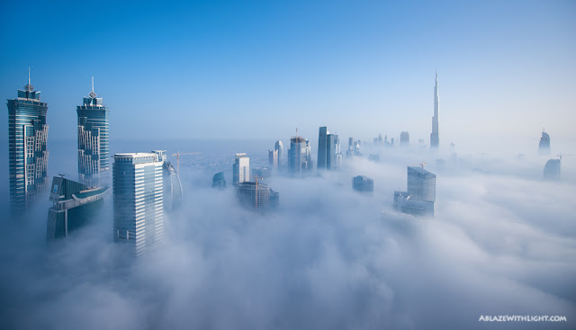 Photo of Downtown Dubai and its skyscrapers above the low fog