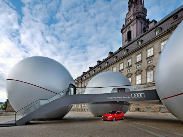 Modern Audi Sphere pavilion with red car