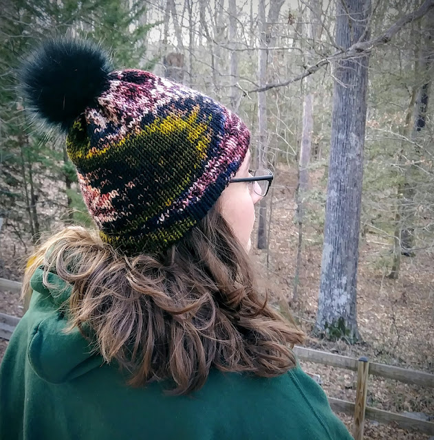 Hemmed brim hat with fur pompom or poof, hand knit with bulky weight wool.