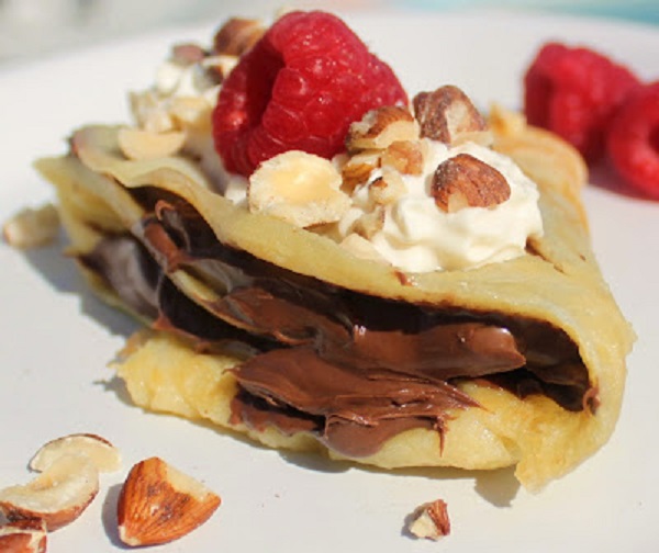 nutella filled crepe with  berries cream and nuts