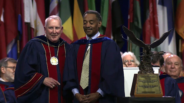The American College of Surgeons Distinguished Lifetime Military Contribution Award was presented to USU President Dr. Jonathan Woodson for his “unrelenting commitment to the advancement of military surgical care.”  (Screenshot photo captured by Cathy Hemelt, USU)