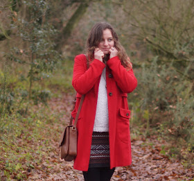 Girl in a red coat in winter