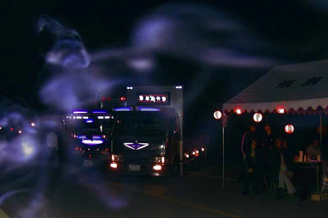 night scene, trucks and smoke, a ghost-like imagery