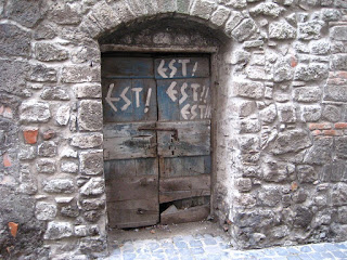 Stone arched doorway in Montefiascone,Lazio, Italy with est! Est!! EST!!! written on it