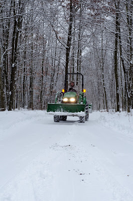 john deer plowing snow in winter