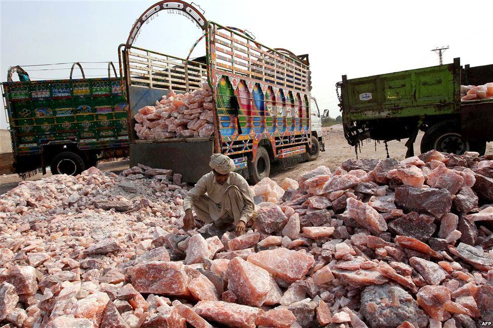 A worker collects salt stones for loading onto a truck outside the Khewra salt mines