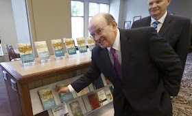 Quentin L. Cook, center, a high-ranking leader with The Church of Jesus Christ of Latter-day Saints, reaches for the "Saints: The Standard of Truth