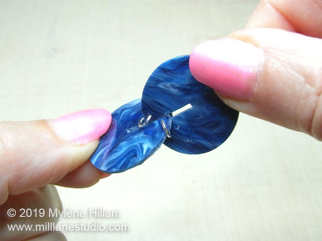 Insert the slits of the two resin circles into each other to form an interlocking orb bead.