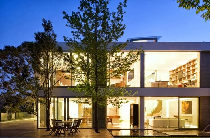 Facade of Modern dream home by Paz Arquitectura at night