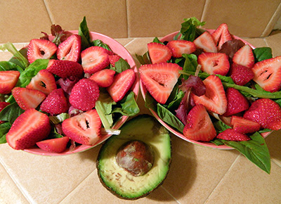 Salad in Progress with Strawberries added and Avocado Ready to Slice