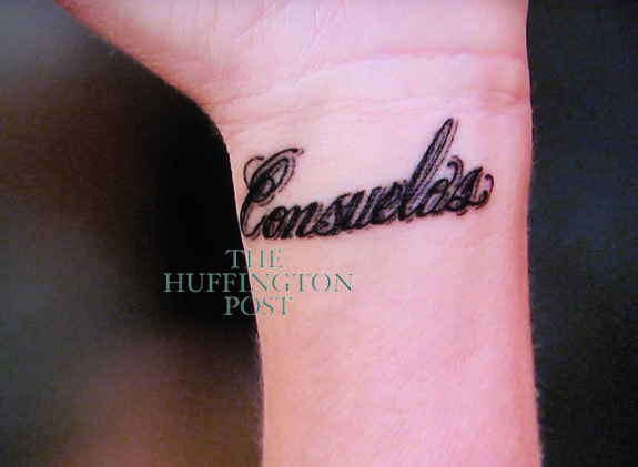 a new word tattooed under an existing Roman numeral tattoo on her wrist