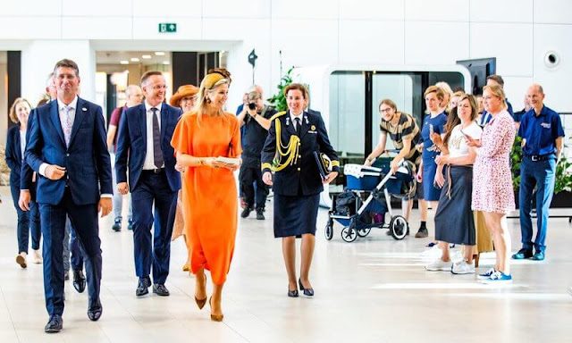 Queen Maxima wore a coral orange belted midi dress by Natan. Gianvito Rossi pumps. A Bag with a Story