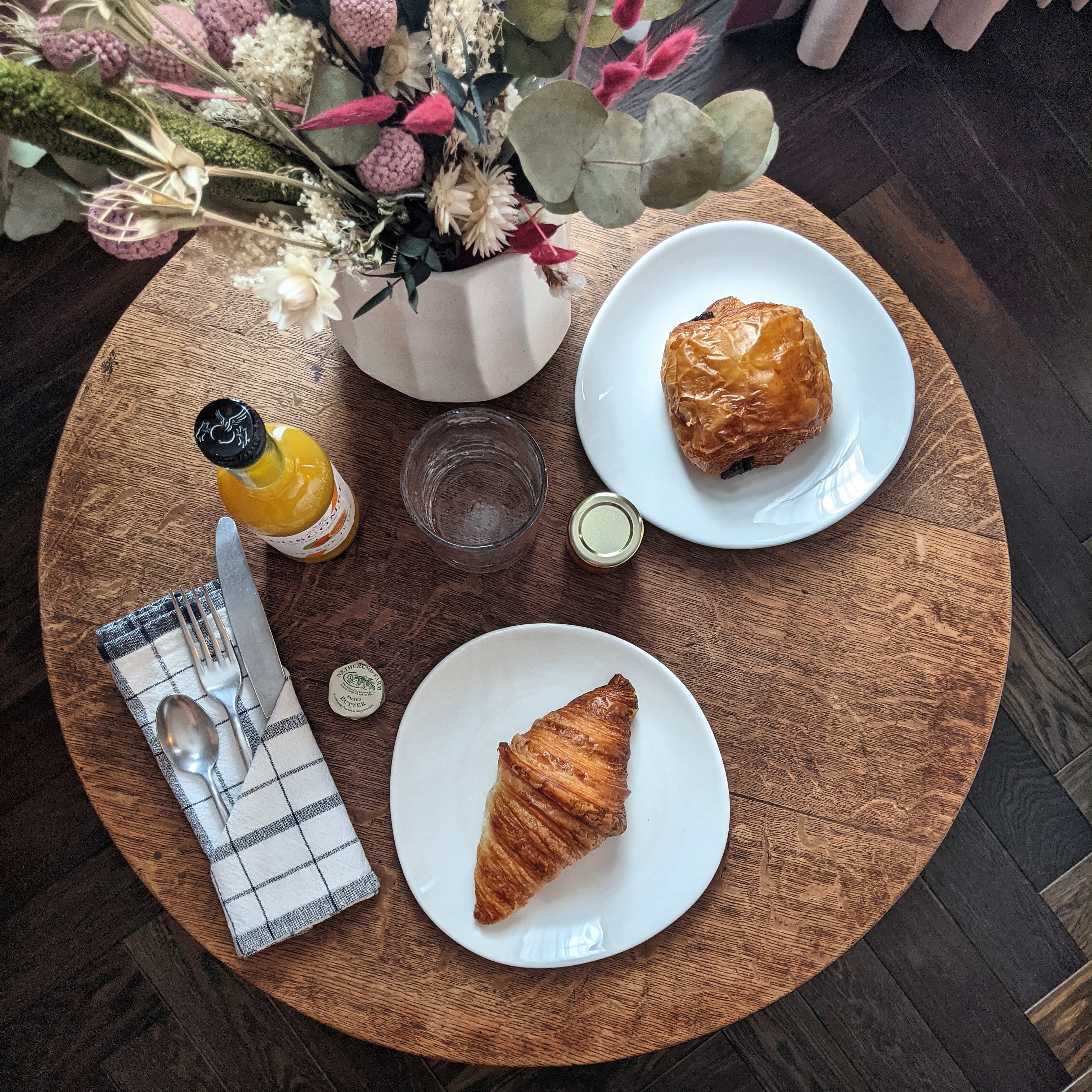 table laid out with croissants and orange juice at the lost poet hotel in London