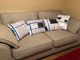 Couch with four cushions made from fabric conference poster