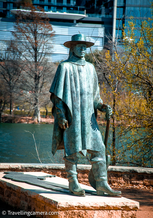 In our last blogpost, we shared about one of the best walks around Colorado river in Austin and after we published that blogpost, to our surprise, lot of viewers showed interest to know more about Stevie Ray Vaughan Statue. Where is Stevie Ray Vaughan Statue on this walk, what's the height of Stevie Ray Vaughan Statue, is there any ticket to see Stevie Ray Vaughan Statue in Austin etc. And after receiving all these questions, I realised that probably I was not aware about the importance of Stevie Ray Vaughan Statue. Now through this blogpost, I am trying to share more with Travellingcamera viewers and will invite others from Austin to help us with relevant details through comments section below.     Let me first address that there is no ticket to see this beautiful Statue of Stevie Ray Vaughan and is located on the shoreline of Colorado river.     Stevie Ray Vaughan Statue is located at Auditorium Shores or Lady Bird Lake in Austin and faces high-rise buildings of Austin Downtown on other side of the river.    Stevie Ray Vaughan Statue was fabricated in 1993 by Argos Foundry of Brewster, which is situated in New York. Stevie Ray Vaughan Statue was installed in 1994 and is now maintained by Austin Parks & Recreation. Stevie Ray Vaughan Statue has become a popular tourist attraction in the Austin City and often has flowers or other devotions at it's base.