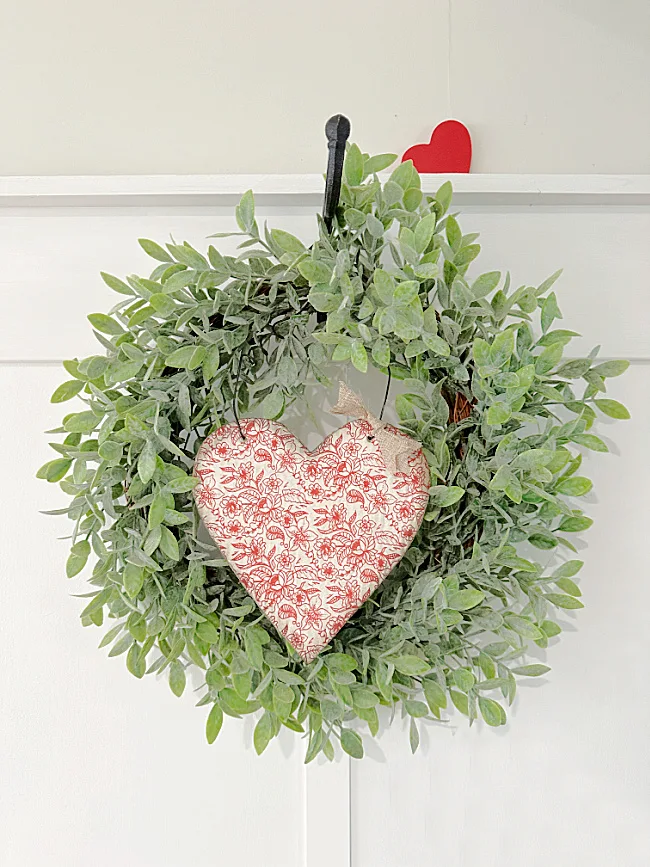 heart in wreath on board and batten wal