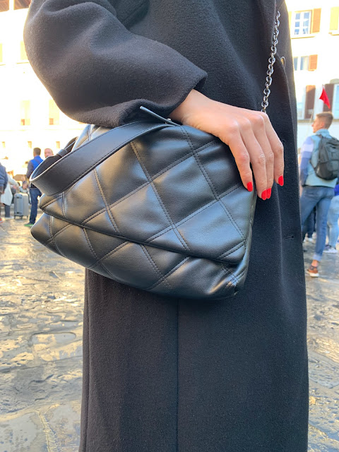 quilted bag and red nails