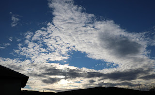 Dramatic clouds accompany the sun as it sets