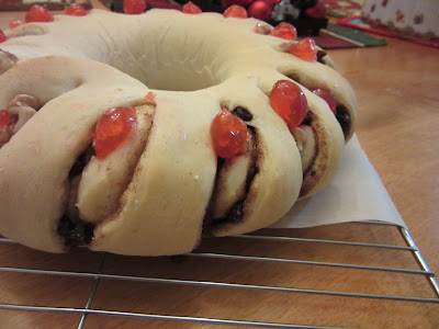 Swetish Tea Ring with walnuts and cherries on baking rack.