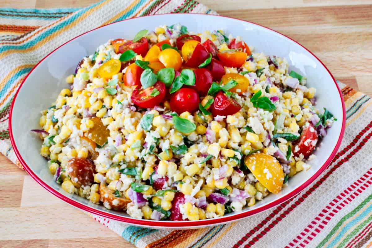 Mexican Street Corn Salad in a bowl with a red rim.