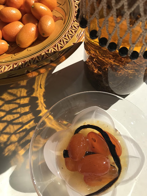 Preserved cumquats and fresh nagami fortunella and calendula infusing in olive oil photo