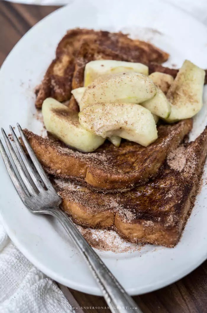 White plate with slices of french toast and apples