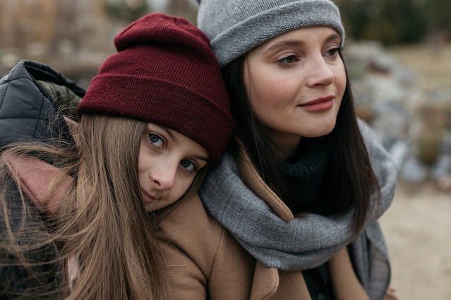 mother and daughter wearing autumn clothing