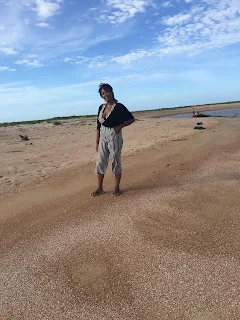 Shachem Lieuw standing on the beach at Braamspunt