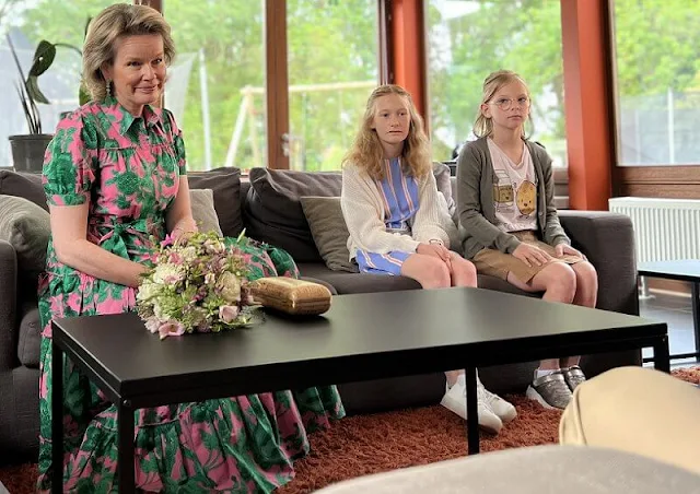 Queen Mathilde wore a new green and pink print queena midi dhirt dress by Diane von Furstenberg. Green leaf earrings and Natan pumps